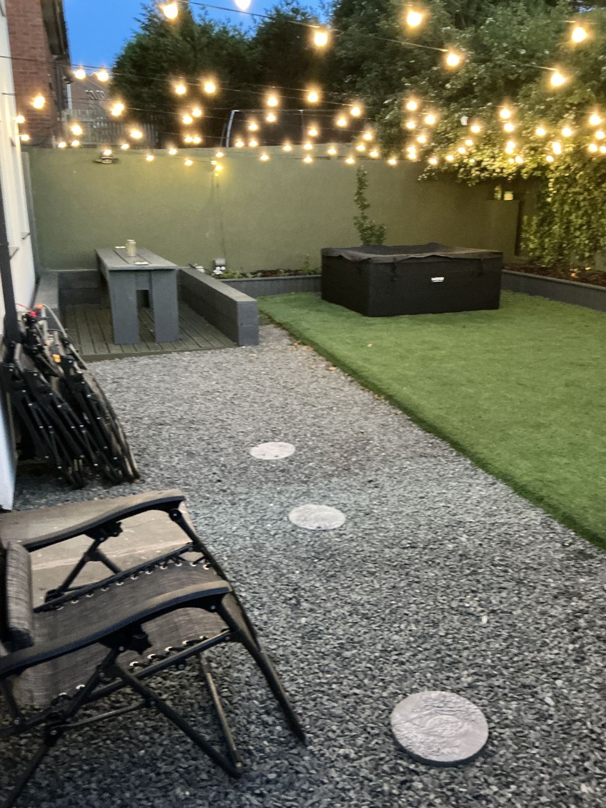 Garden with festoon lights in the evening